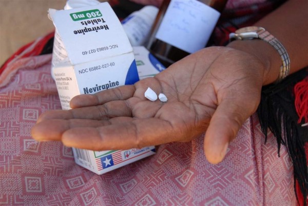 In Lesotho, A woman holds the AIDS anti-retroviral treatment medicine for her granddaughter.