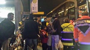 Refugiados suben a un bus que los llevará a sus alojamientos.