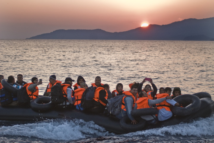 October 4,2015-Lesvos, North-east Aegean sea, Greece: Refugees arrive into a small plastic and cheap boat to the coast of the Greek island Lesvos from the Turkish land (Maro Kouri)