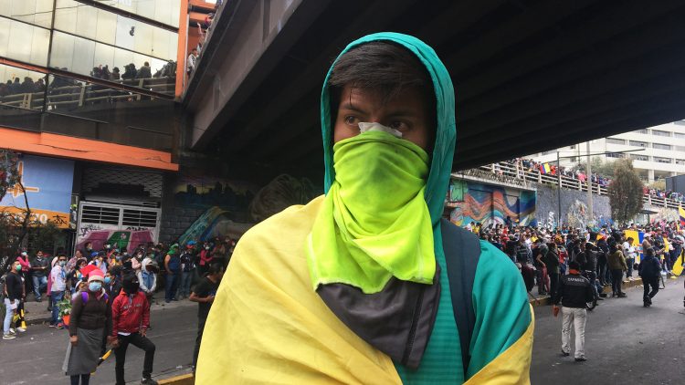 Durante las movilizaciones de Octubre en Quito, un joven observa.