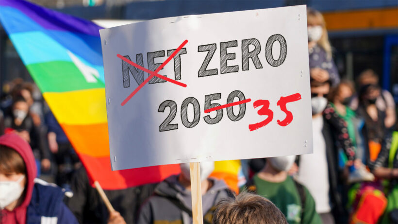 Photo a street protest sign saying "Net Zero 2050" with the word "Net" crossed over and 2050 changed to 2035.