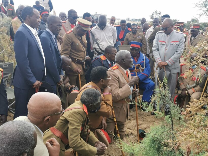 A group of Ovaherero elders led by a traditional priest in summoning the spirits of the ancestors (genocide victims) before paying homage to them in the unmarked gravesite.
