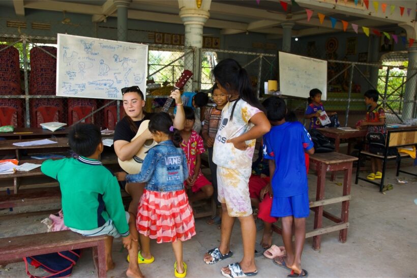 Volunteer Molly Smith sings with the children in the morning class