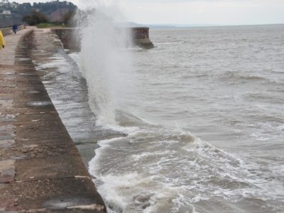Waves breaking on the sea wall at Teignmouth, England. Wikimedia Commons