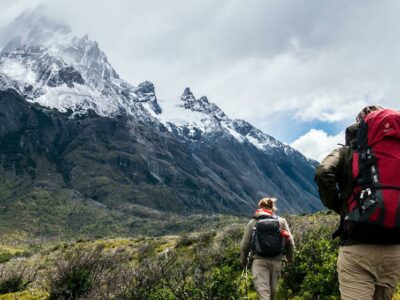 Unsplash/Toomas TartesTwo hikers trek the mountains of Chile.