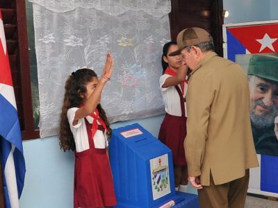 Cuba's President Raul Castro casts his vote during the Municipal Elections beside an image of late Cuba's President Fidel Castro in Havana, Cuba November 26, 2017. Courtesy of Estudios Revolucion/Handout via REUTERS