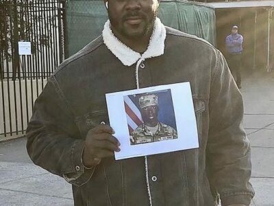 Mohammad Latifu, holding photo of his brother Abdul Latifu, murdered Jan. 10, 2023, at Fort Rucker, Alabama.