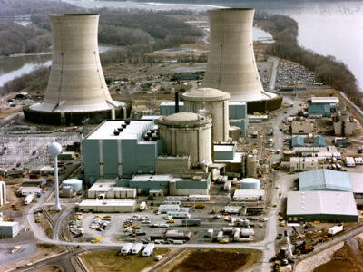 Color photograph of the Three Mile Island nuclear generating station, which suffered a partial meltdown in 1979. The reactors are in the smaller domes with rounded tops (the large smokestacks are just cooling towers). Wikimedia Commons.