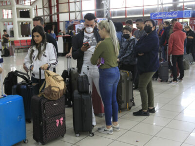 Several people, mainly women, stand in line to check their tickets at Terminal 3 of José Martí International Airport in Havana. According to the International Organization for Migration, women account for 48 percent of international migrants worldwide, and an increasing number of them are migrating independently.