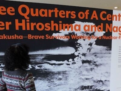 Erico Platt looks at the disarmament exhibit he organized, titled "Three-quarters of a Century after Hiroshima and Nagasaki: The Hibakusha, Courageous Survivors Working for a World Without Nuclear Weapons."