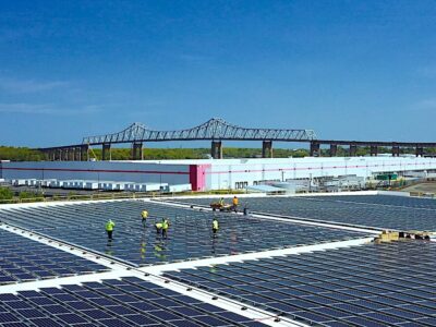 Workers install solar panels on the rooftops of warehouses in Secaucus, New Jersey. Brendon Shank.