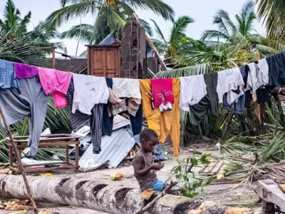 A boy sits amid scenes of destruction in Macomia town after it was hit by tropical cyclone Kenneth, which made landfall in Cabo Delgado province in Northern Mozambique, on 25th April 2019.