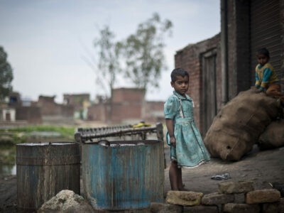 Children plays outside a metal polishing work-shop in the Shivnagar Mohalla slum in Moradabad district in Uttar Pradesh.