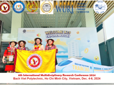  PHAS graduands Jocelyn G. Nitron, Irene M. Wakat, Dr. Genevieve B. Kupang, and Camella Mae Mangili, donning traditional Vietnamese hats, pose at the entrance of Bach Viet Polytechnic while proudly displaying BCU’s banner during the 6th IMRC.