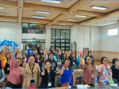 Dr. Genevieve Balance Kupang, Dean of the Graduate School and International Relations Officer, joins enthusiastic graduate students as they proudly display the peace sign with their smiles.